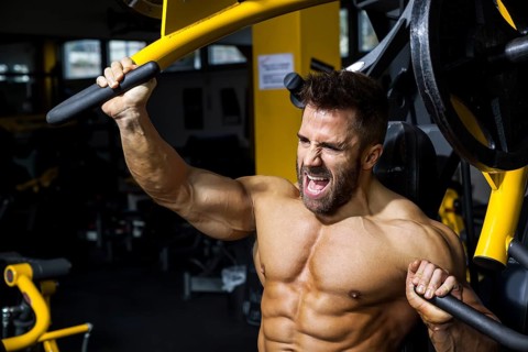 An image of a handsome bearded bodybuilding man doing chest workout