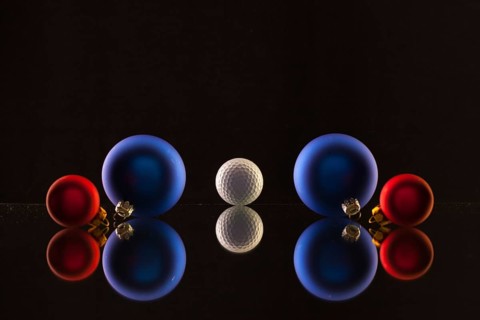 Golf ball and Christmas decoration on the glass table