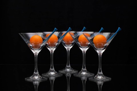 Five glasses of champagne with golf balls
