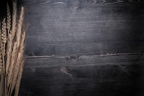 Wheat rye ears on wooden board food and drink concept