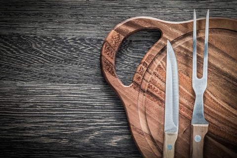 Meat fork knife chopping board on vintage wooden background