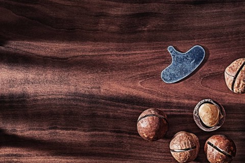 Nuts Of Macadamia On Vintage Wood With Copy Space