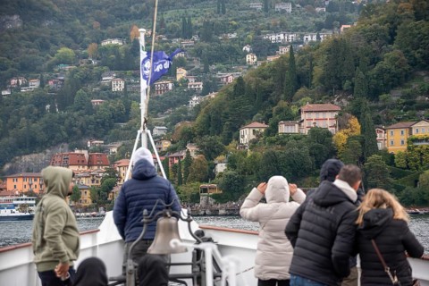 VARENNA, ITALY, OCTOBER 05, 2023, Tourists waiting for the ferry to dock at the harbor of Varenna,
