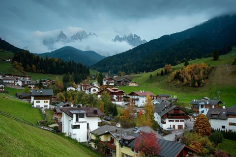 Picturesque village of Val di Funes with the dolomite rocky mountains in Italy at night
