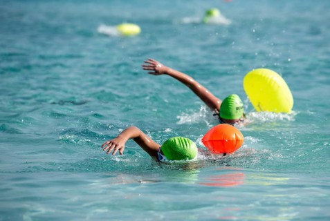 Athletes swimming free style in the sea during race competition. Aquathlon Swimmer in the ocean