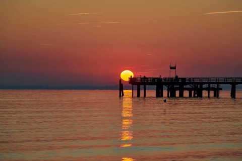 Red sunrise over the sea at the pier of the Baltic Sea resort, Boltenhagen, Mecklenburg-Vorpommern,