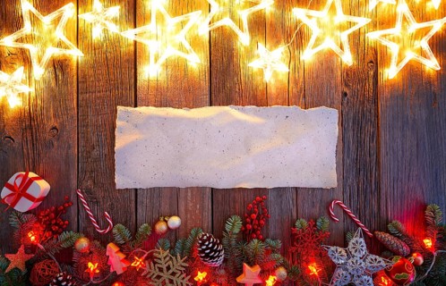 Christmas glow stars and fir white paper parchemin copy space on vintage wood