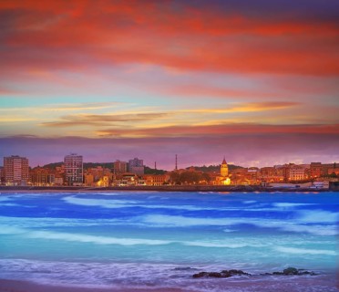 Gijon skyline sunset in San Lorenzo beach of Asturias in Spain