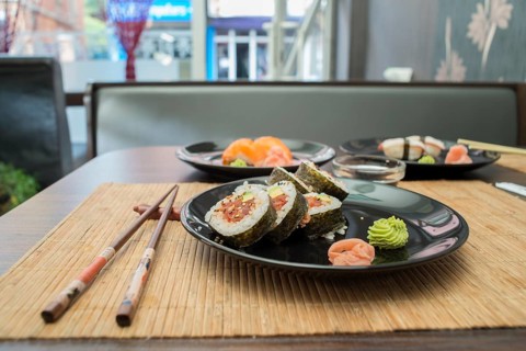 Sushi in sushi bar. Table and ration sushi