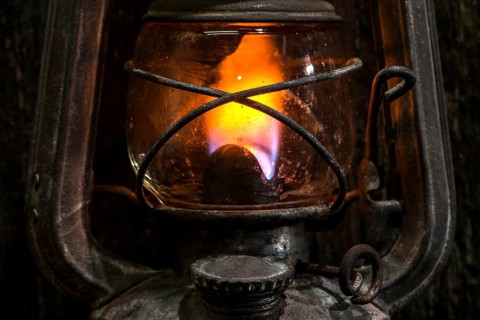 Old gas lantern on wood at darkness