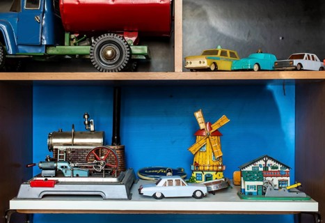 Old vintage toys on shelf. Collection of vintage cars toys in a shop. Bright colours