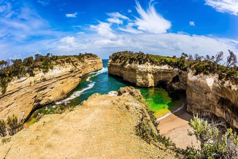 Small picturesque bay with green ocean water. The Great Ocean Road of Australia. The Pacific ocean.