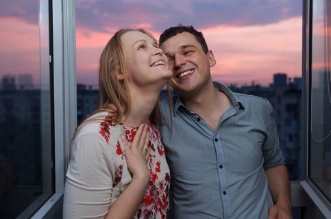 Playful young couple enjoying their new own apartment