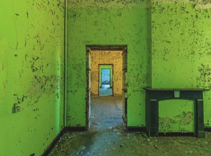 Dilapidated room with bright green wall colour and old fireplace, Prison H11, Lost Place, Verviers,