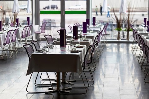 Indoor restaurant tables ready for service. Small GRIP contrejour (against the light) shot