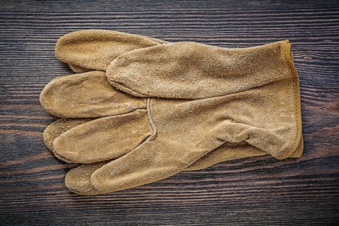 Pair of working gloves on vintage wooden board directly above agriculture concept