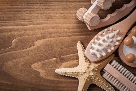 Set of massagers starfish and scrubbing brush on pine vintage board healthcare concept