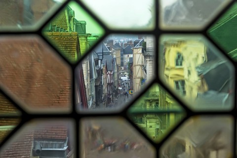 Rouen, France, August 30, 2018: View of the city street through the old window on the clock tower