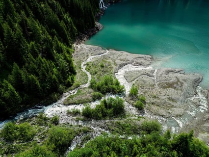 Top view of a forested landscape with winding streams leading to a lake, nature, water, ice,