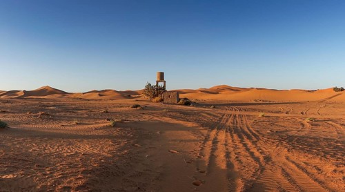 View of offroad vehicle tracks leading into the sand dunes of Erg Chebbi in the Sahara Desert of