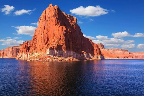 Lake Powell is surrounded by magnificent sandstone hills. Scenic huge artificial water basin of the