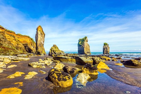 Picturesque rocks Three Sisters on the Pacific coast. The concept of active and phototourism. New