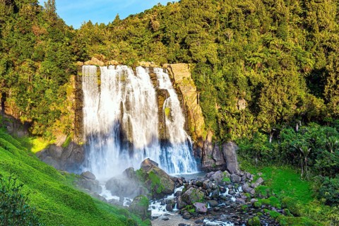 North Island. The largest and widest waterfall in Marocopa. The setting sun illuminates the stormy