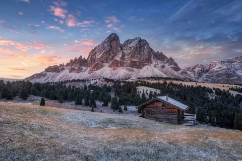 Passo Erbe under the mountain Peitlerkofel, or Sass de Putia before sunrise with wood hut
