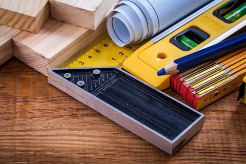 Square ruler pencil blueprints wooden meter and studs construction level on vintage wood board