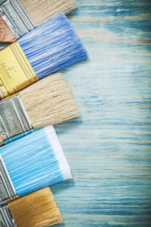 Set of paint brushes on wood board construction concept