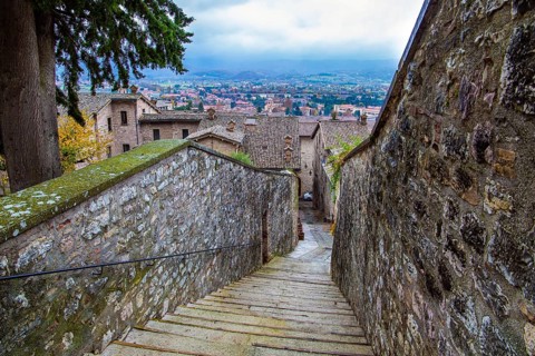 Narrow cobblestone trail leads to the top of the hill. Autumn cloudy day. Magnificent Italy. The