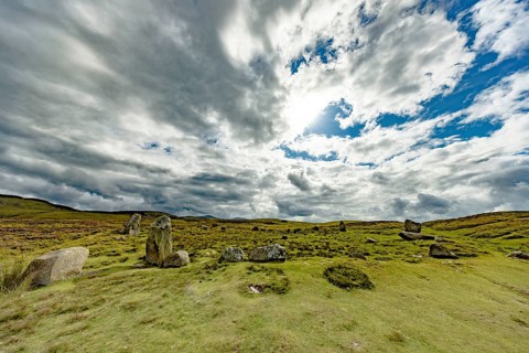 Druids Circle, stone circle in wide landscape with pastures in the mountains, Penmaenmawr,