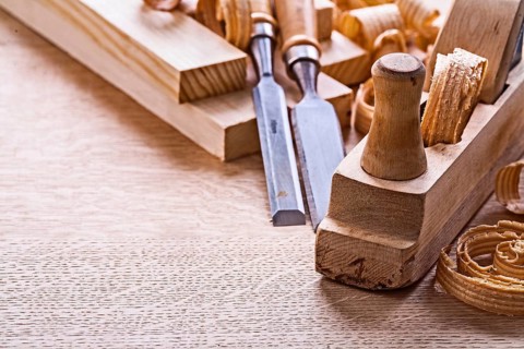 Veri close up view old fashioned plane chisels planks shavings on wooden board