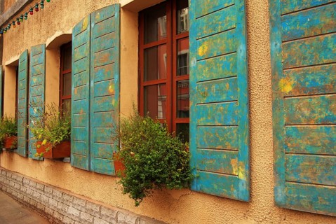 Windows of antique house decorated with flowers