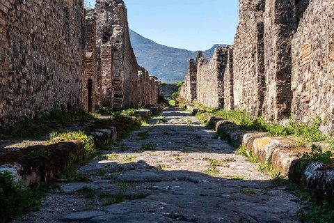 POMPEII, ITALY, MAY 04, 2022, A beautiful typical cobbled street in the ancient city of Pompeii,
