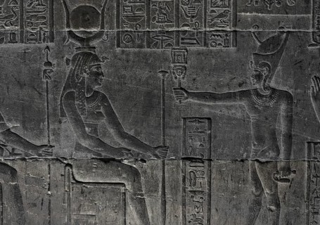 Hieroglyphic carvings on the wall of an ancient egyptian temple