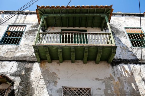 Low angle view of a green roofed balcony at an old house in Old Town Cartagena, Brazil, South