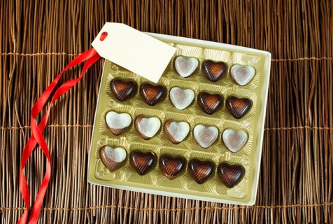 Chocolates in the shape of hearts. Chocolates in golden box and label