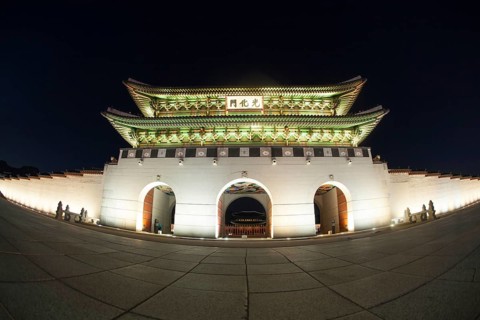 Wide angle shot of the illuminated Gwanghwamun Gate at night. Sightseeing of Seoul, South Korea,