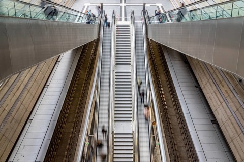 Escalator leads with motion blur through modern glass architecture, Leipzig Central Station