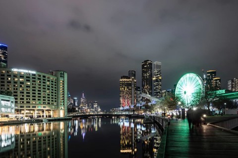 MELBOURNE, AUSTRALIA - JULY 5, 2024: Polly Woodside Park and ferris wheel and Melbourne skyline as