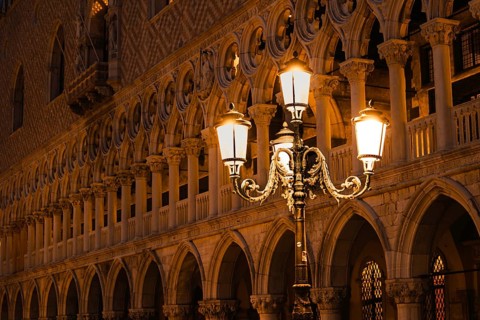 Illuminated street lamp in front of a magnificent Venetian façade at night, Doge's Palace, St