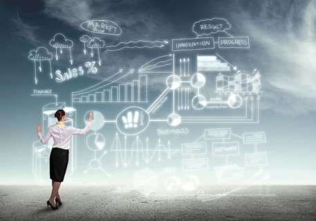 Back view of businesswoman drawing business plan sketches