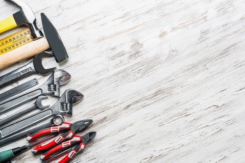 Variety of repair tools on wooden surface
