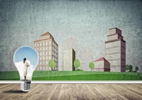 Businesswoman inside light bulb against city drawn concept