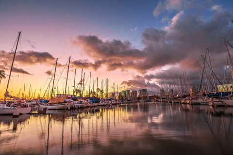 Dramatic landscape of sailing boats and yachts docked at the Ala Wai Harbor, the largest yacht