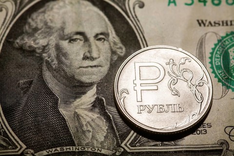 One ruble coin on dollar banknote. Closeup, macro shot
