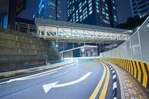 Empty asphalt city street road with walkway bridge and light trail, night scene