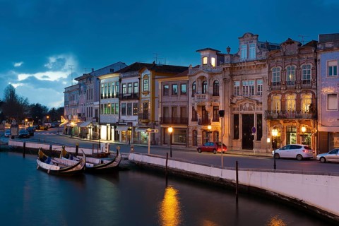Moliceiro boats docked and Art Nouveau style buildings, Aveiro, Portugal, Europe