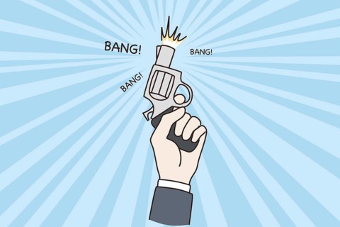 Business startup and new project concept. Human hand holding pistol gun ready to shoot for new